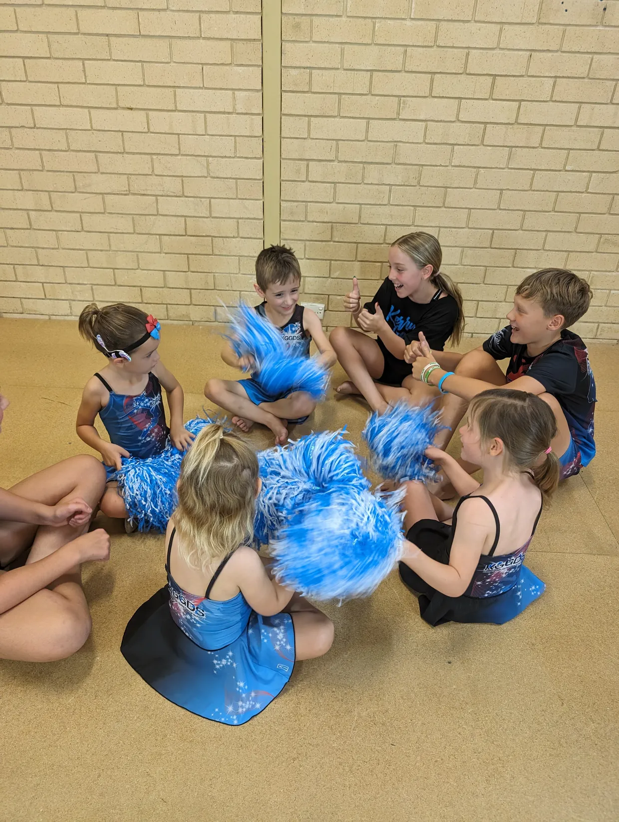 Tiny tots students having fun with pompoms.