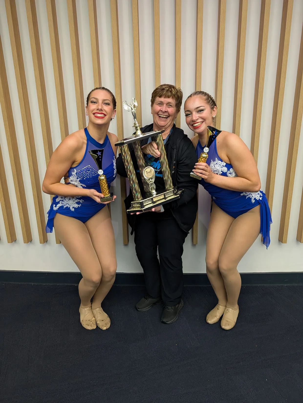 Kerry and 2 private lessons students holding trophy they won.